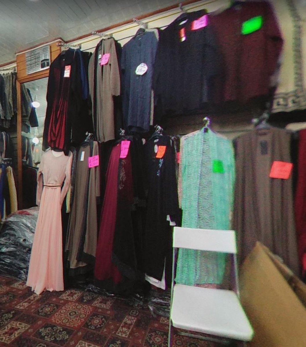 Clothing rail inside Gifts Shopping Centre, with dresses in a range of colours