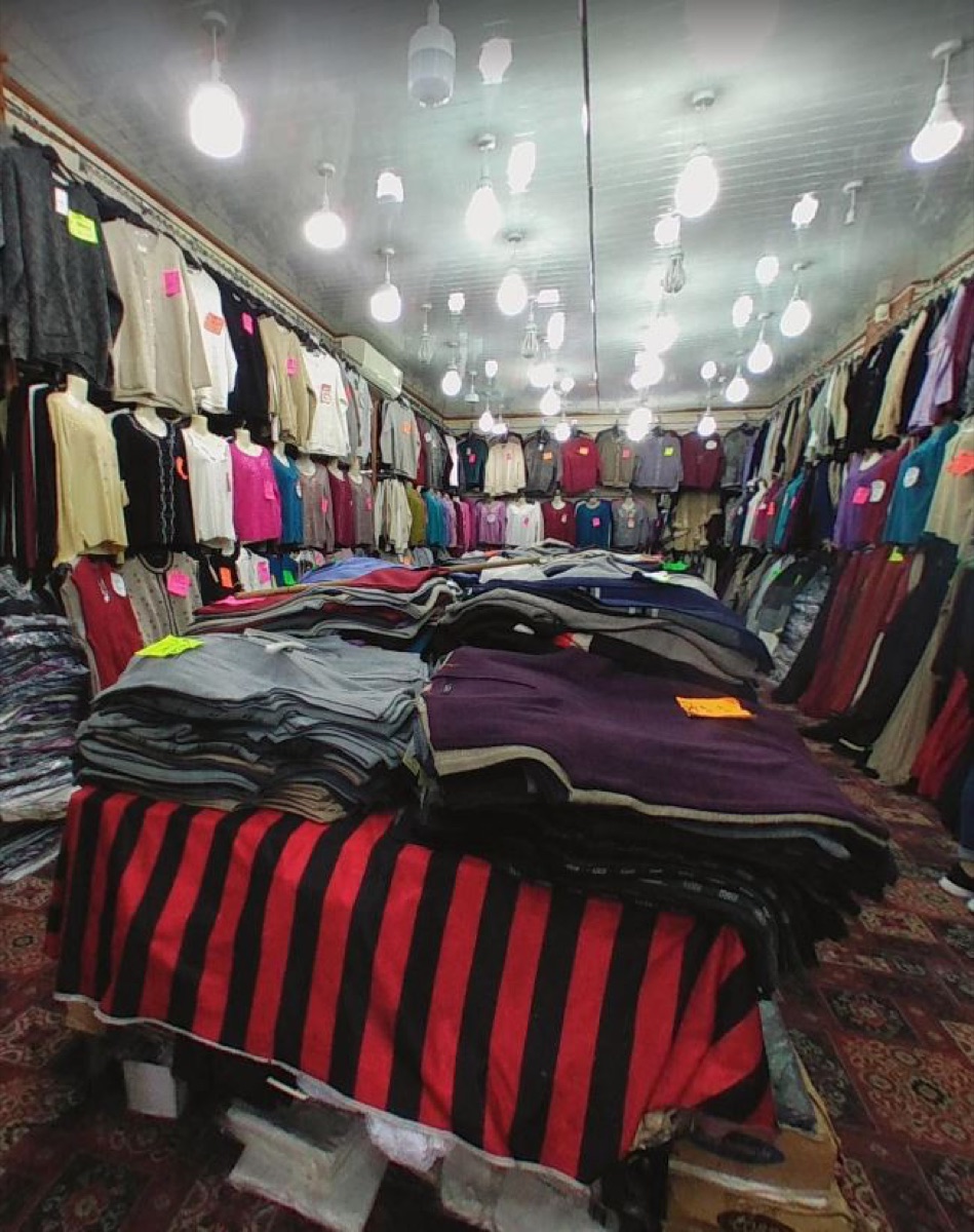Folded knitwear laid out on tables inside Gifts Shopping Centre